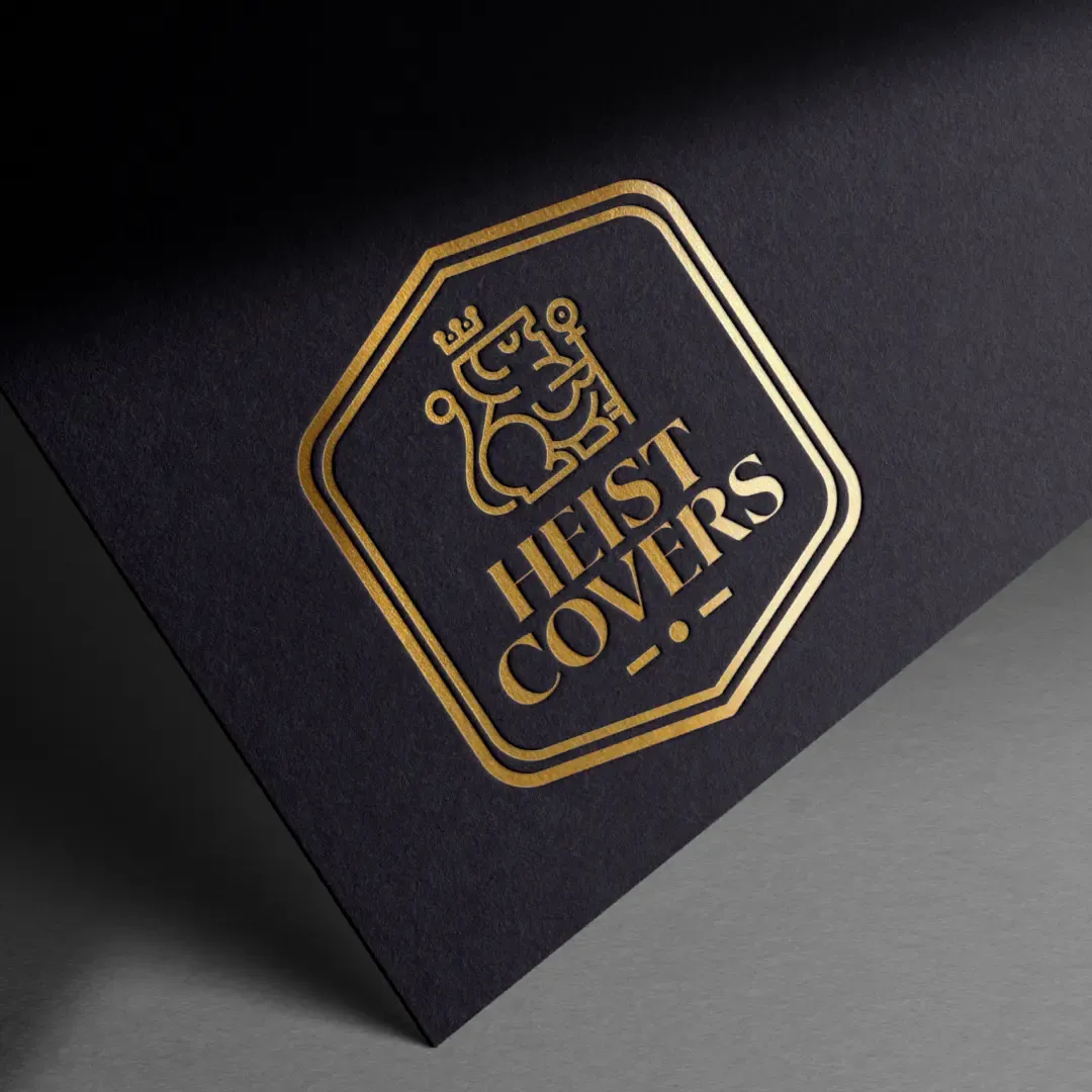 Heist Covers full logo badge in gold foil pressed on dark navy textured paper