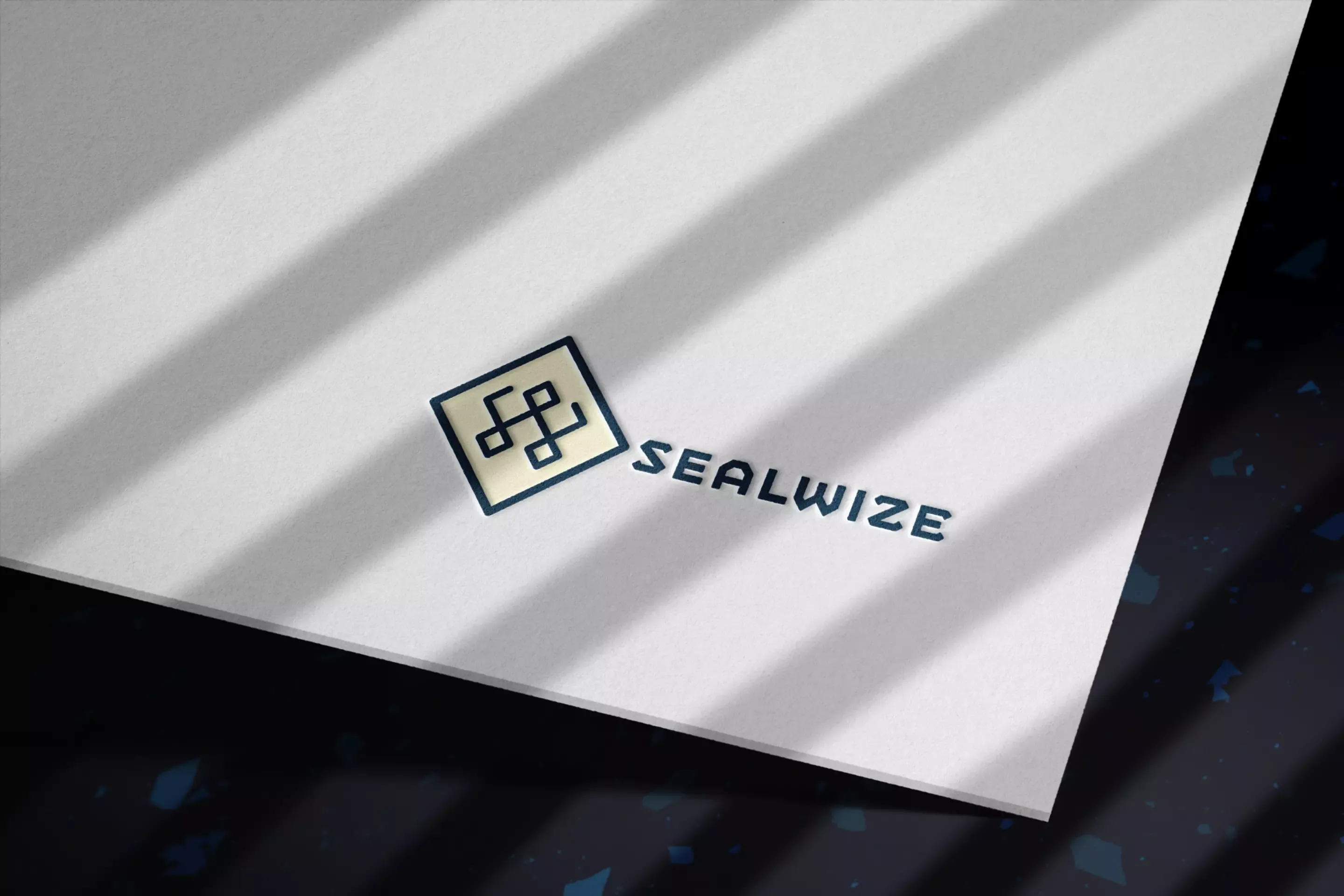 New Sealwise geometric logo design on paper, showing the interlocking diamond icon with clean modern wordmark