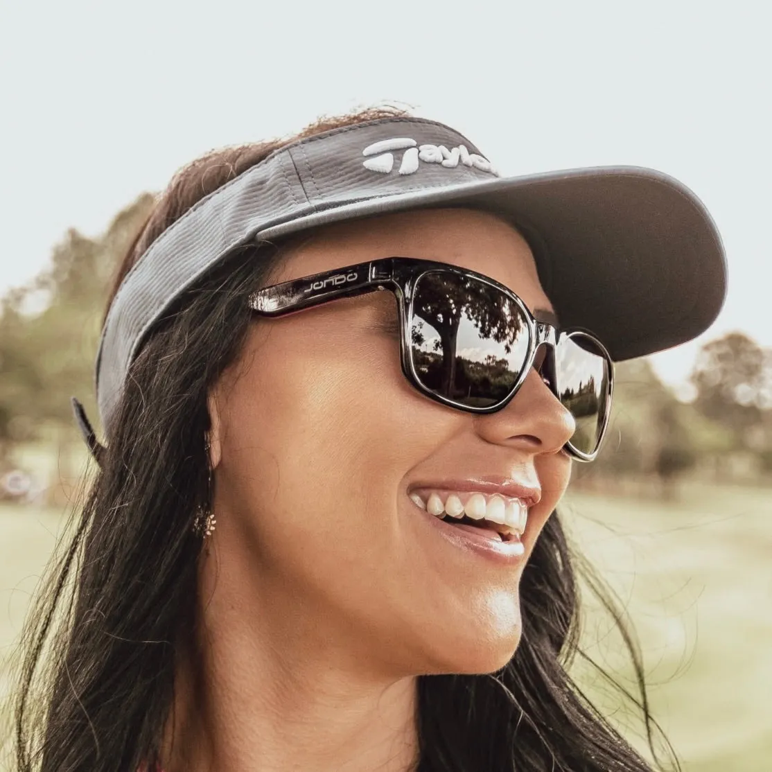 JondoSport Sandy model shown in outdoor lifestyle setting, demonstrating the brown frame option for golf